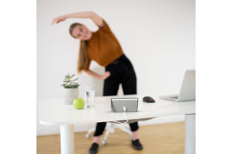 Young woman does exercise at work with Isa
